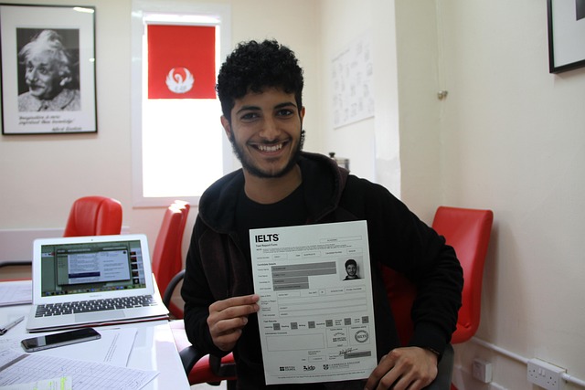 A happy student showing his IELTS result with a smile after identifying keywords in IELTS reading